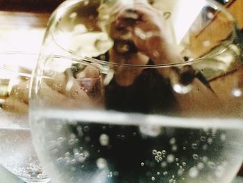 Close-up of glass with reflection of water