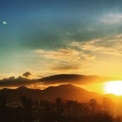 Scenic view of mountains against sky at sunset