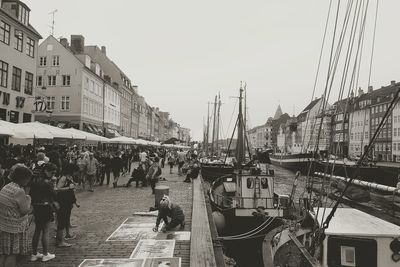 Panoramic view of boats in city against clear sky