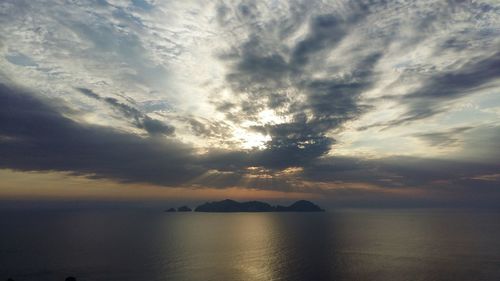 Palmarola island and sea against cloudy sky during sunset