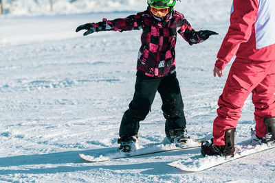 Boy and instructor on snowboarding class