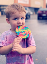 Cute boy eating lollipop