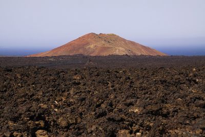 Scenic view of arid landscape against clear sky