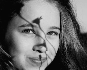 Close-up portrait of cute girl in sunny day