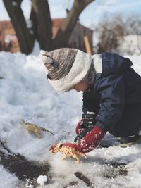 Side view of man standing on snow