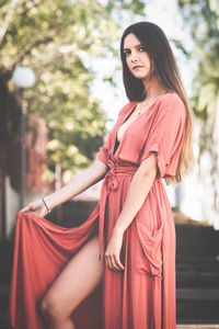 Portrait of young woman standing outdoors