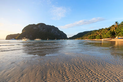 View of beach with mountain range in background