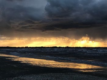 Scenic view of beach against sky during sunset
