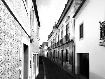 Narrow alley amidst buildings against sky