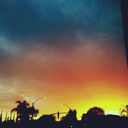 Low angle view of silhouette trees against sky at sunset