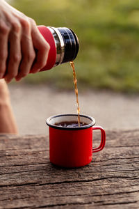 Cropped hand holding coffee