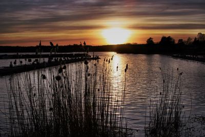 Scenic view of lake against sky during sunset