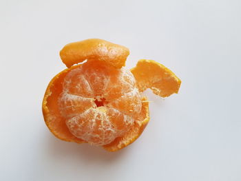 Close-up of orange slice against white background