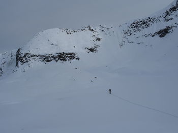 Scenic view of snow covered mountain against sky