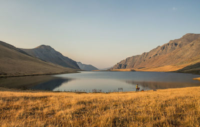 Scenic view of lake and mountains against sky