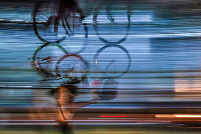 Blurred motion of woman walking on road