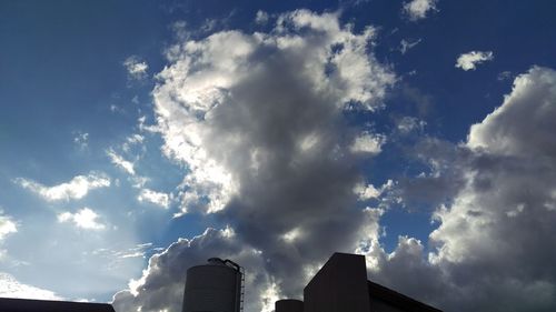 Low angle view of building against cloudy sky