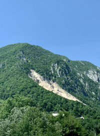 Scenic view of mountains against clear blue sky