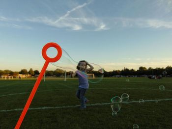 Girl playing on grassy field