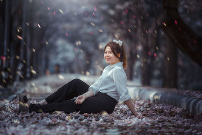 Side view of woman sitting outdoors