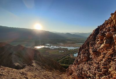 Panoramic view of landscape against bright sun