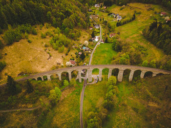 High angle view of bridge over road amidst trees