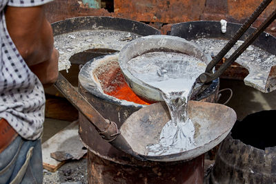 Low section of man melting aluminum