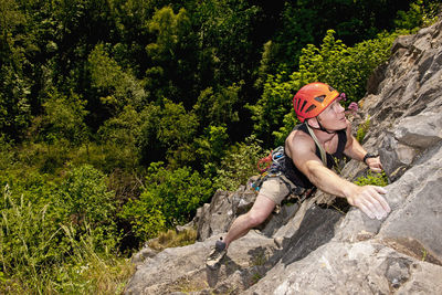 Man climbing limestone cliff in south wales