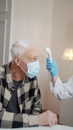 Side view of doctor examining patient at clinic