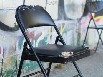 Close-up of old chair with torn cushion 