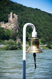 Boat's bell on a river with a castle in the background