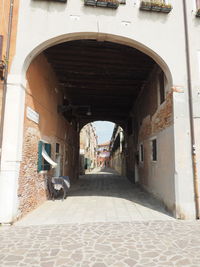 Empty alley amidst buildings in city