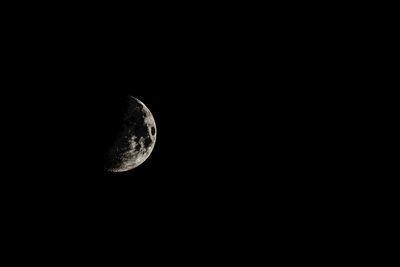 Low angle view of moon against dark sky