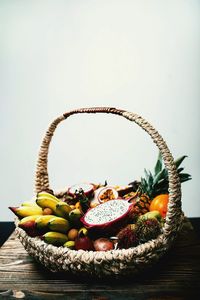 Fruits in basket on wood