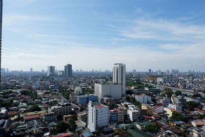 View of cityscape against cloudy sky