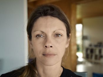 Close-up portrait of mature woman at home