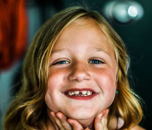 Close-up portrait of smiling girl outdoors
