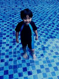 Portrait of boy standing in swimming pool