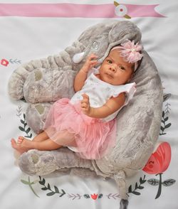 High angle view of baby girl lying on bed at home