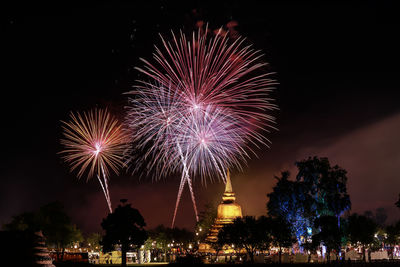 Firework display in city at night