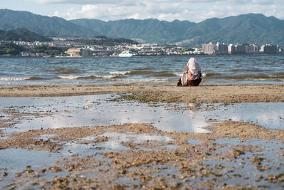 Rear view of woman on beach