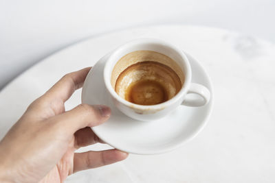 Midsection of coffee cup on table