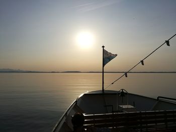 Silhouette of boat sailing in sea at sunset