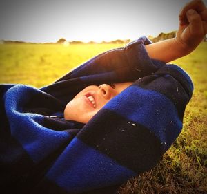 Close-up of boy hand against clear sky