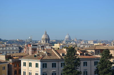 Cityscape against clear blue sky