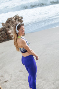 Full length of young woman on beach