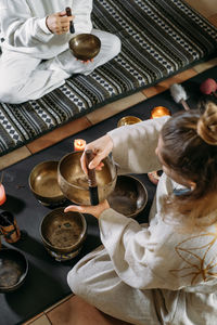 High angle view of woman sitting on table