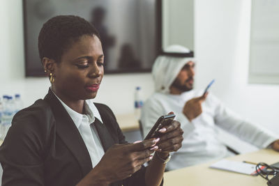 Close-up of woman holding mobile phone