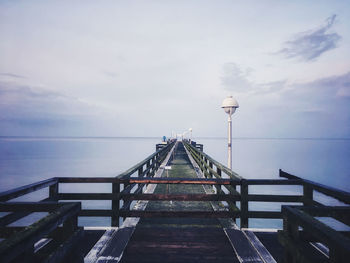 Pier over sea against sky