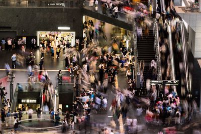 Crowd walking on street in city